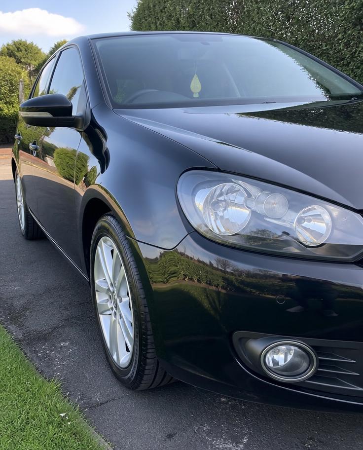 Glossy car paint and polished wheel after MirrorFinish detailing